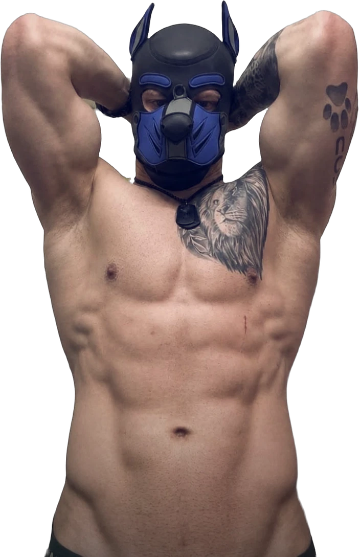 Pup Bacu in a black and blue pup hood, shirtless, arms behind his head.
