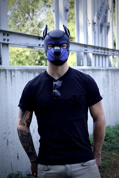 Pup Bacu in hood and black shirt on a steel bridge